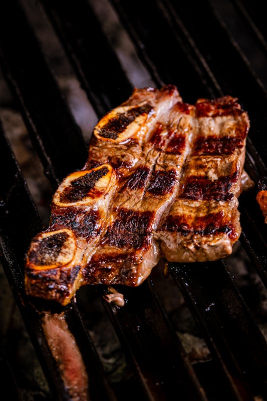 Smoked beef short ribs with dark bark on grill grates