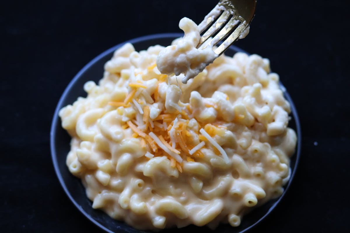 Creamy mac and cheese topped with shredded cheese