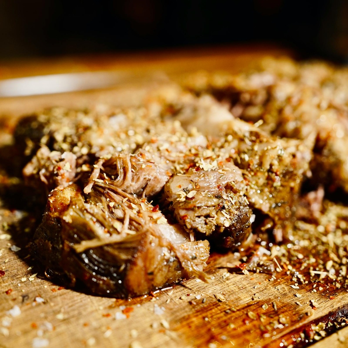 Tender pulled pork on cutting board ready to shred