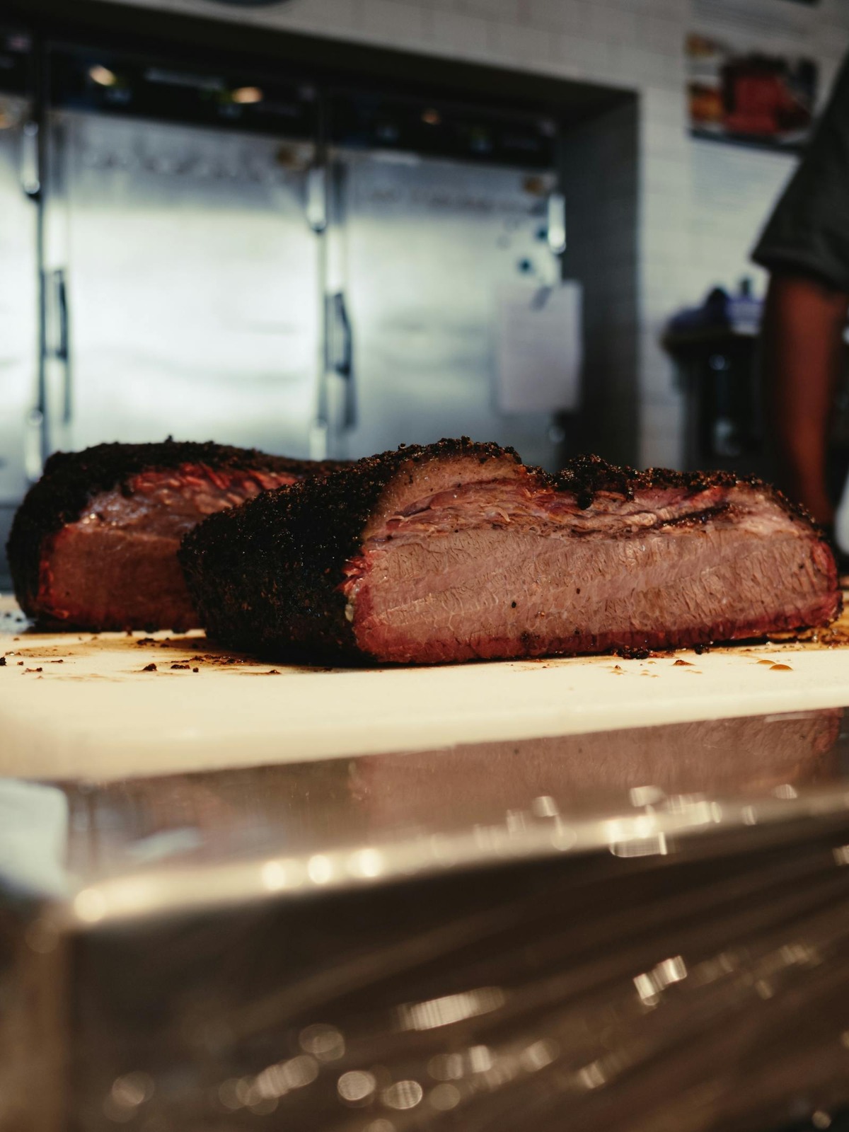 Sliced smoked brisket showing dark peppery bark and pink smoke ring