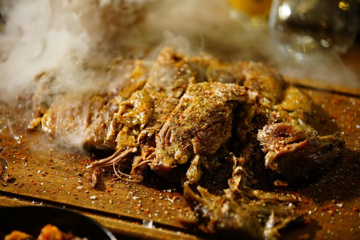 Steaming pulled pork on a wooden cutting board